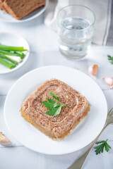 Meat aspic in a plate with mustard