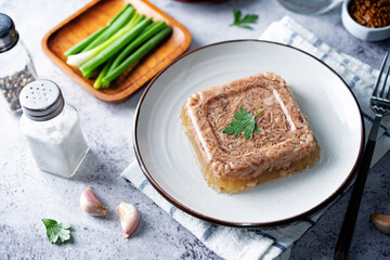 Meat aspic in a plate with mustard