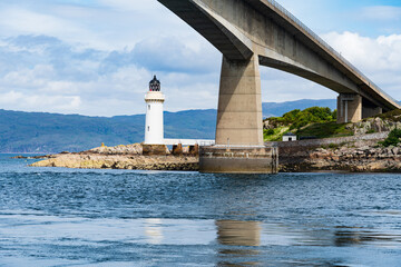 The Scottish Skye Road Bridge as it connects to the small island Eilean Ban in Loch Alsh, Scotland, UK.  Also shown is the Kyleakin Lighthouse - 448389487