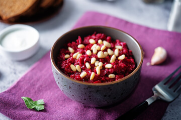 Beetroot salad with pine nuts in a bowl