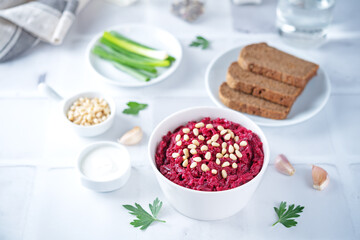Beetroot salad with pine nuts in a bowl