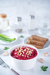 Beetroot salad with pine nuts in a bowl