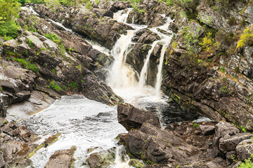 The Rogie Falls, a series of waterfalls near the village of Contin, Ross-Shire, Scotland, UK, viewed here from the suspension bridge. - 448389677