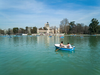 Fototapeta na wymiar Lake of the Retiro Park ( Parque del Retiro ) in Madrid with people paddling in boats
