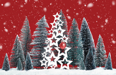 Many Christmas trees with snow and wooden trees with red bauble. Merry Christmas and a Happy New Year in snow. Seasons greetings card. Red background