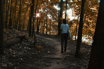 Young latin woman walking through an autumn forest