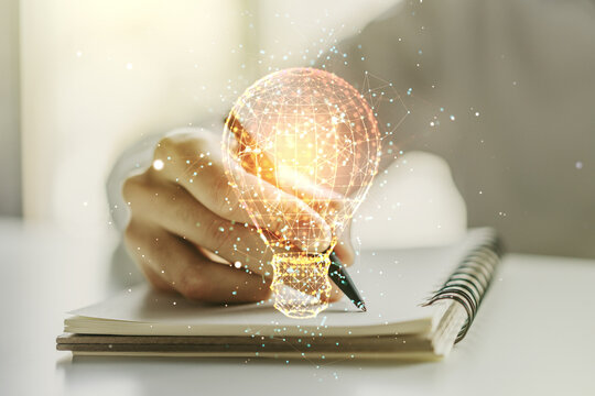 Creative idea concept with light bulb illustration and hand writing in notebook on background. Multiexposure