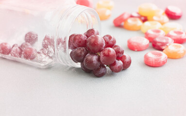 Group of Grapes with waterdrops put beside blurred glass bottle,
