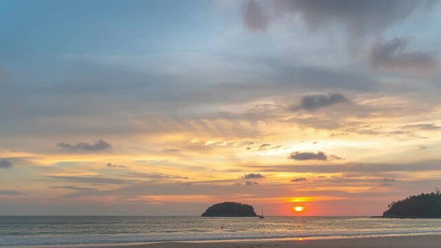 time lapse beautiful sunset over the sea..beautiful moving cloud in golden sky at sunset in Kata beach Phuket Thailand.4k stock footage video in travel concept.