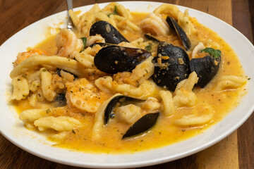 Seafood Pasta containing Fusilli, Mussels, Shrimp, Calamari, and Scallops