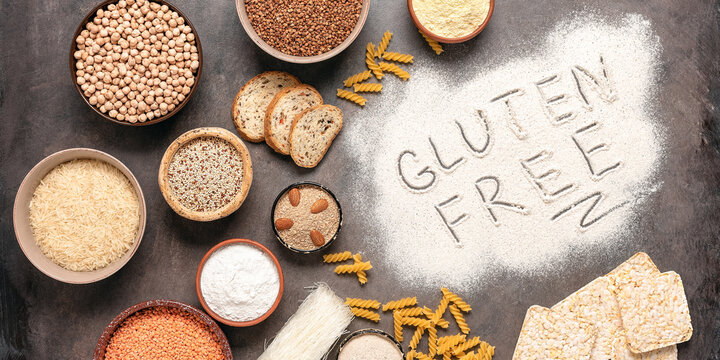 Selection of gluten free food on a rustic background. A variety of grains, flours, pasta, and bread gluten-free. Top view, flat lay,wide composition.