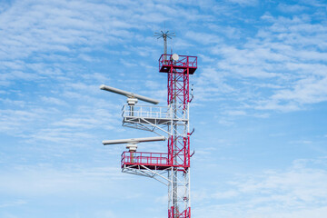 Telecommunication antenna for mobile network services, radar and ship communication with a blue sky.
