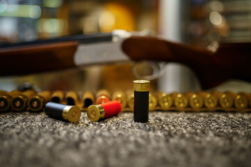 Obraz na płótnie Canvas Hunting rifle, bandolier and cartridges, gun store