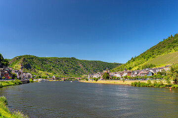 Fototapeta na wymiar Cochem, Germany, June 13, 2021. Beautiful view of the colorful buildings along the river with a bridge and the old town of Cochem on the Moselle river in Rhineland-Palatinate, Germany.