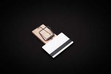 Credit Risk and Loan Trap - White Blank Credit Card Template in Wooden Mouse Trap on Black Background