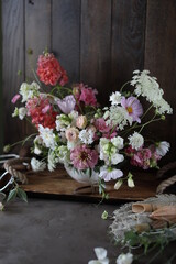 Floral arrangement of summer garden flowers in pastel shades on the table. English floristry. Still life.