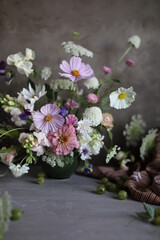 Floral arrangement of summer garden flowers in pastel shades on the table. English floristry. Still life.