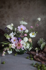 Floral arrangement of summer garden flowers in pastel shades on the table. English floristry. Still life.