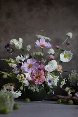 Floral arrangement of summer garden flowers in pastel shades on the table. English floristry. Still life.