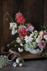 Floral arrangement of summer garden flowers in pastel shades on the table. English floristry. Still life.