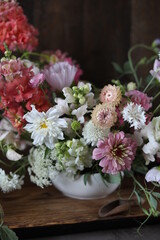 Floral arrangement of summer garden flowers in pastel shades on the table. English floristry. Still life.