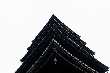 Close up Matsumoto castle roof top against white isolated sky in Japan.
