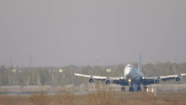 Front view, landing of a huge four-engine airliner