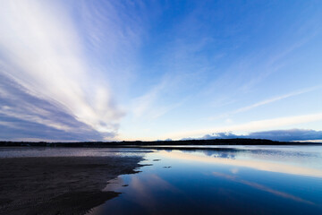 Beautiful twilight scene and sky reflection from Red Wharf Bay with the tide slowly making it's way into the bay, Anglesey, North Wales