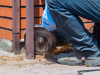 locksmith cuts the gate with a diax grinder