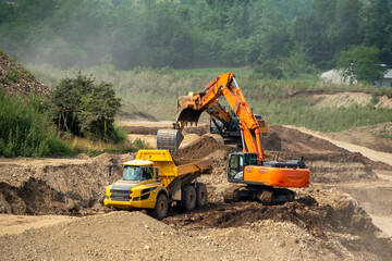 Dump truck and excavator at work © oigro