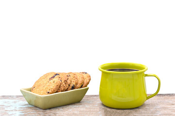 black coffee in green metal cup  and oat crackers on  white background