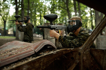 Warriors aimimg with paintball guns, team game