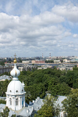 Obraz premium Saint Petersburg, Russia, July, 20, 2021: panoramic top view of the city and church architectural fragments from the bell tower of the Resurrection Smolny Cathedral on a sunny summer day