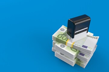 Rubber stamp on stack of money