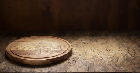 Pizza cutting board for homemade bread cook or baking on table. Empty pizza board at wooden tabletop