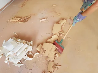 Deurstickers home renovation - removing the old floor covering with a scraper © SusaZoom