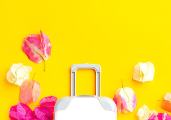 Pink flower petal bougainvillea on yellow background. Travel concept, Copy space.