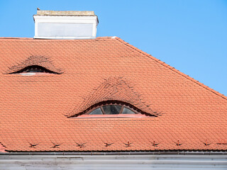 Old medieval house with red brick roof tiles