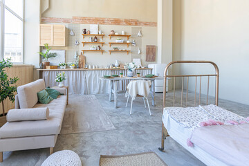 simple cozy home interior of an open plan ordinary room with a kitchen and bedroom area