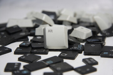 Alt key in the foreground, group of keyboard buttons. Black, gray and white keys out of focus....