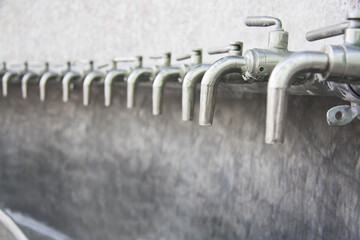 Row of closed drinking water taps. Fountains of natural water source structure.