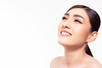 Happy beautiful young girl showing beauty face with natural make up looking to copy space Pretty asian woman clean fresh skin Expressive facial expression Cosmetology beauty and Spa concept copy space