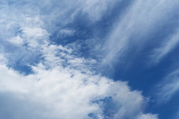 white fluffy clouds on blue sky in summer on sunny day