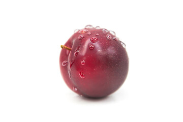 Ripe fresh organic plum in water drops isolated on white background.