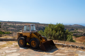 deserted tractor above sunny valley