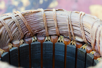 Disassembled electric motor winding coil. View of inside of electric induction motor. Coil copper...