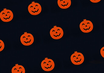 Black Halloween background with  scary pumpkins.
