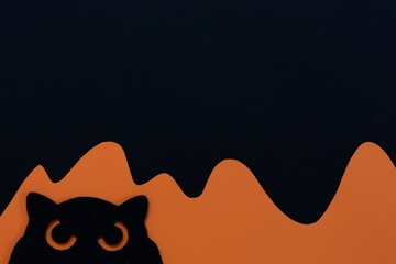 Black and orange Halloween background with owl silhouette