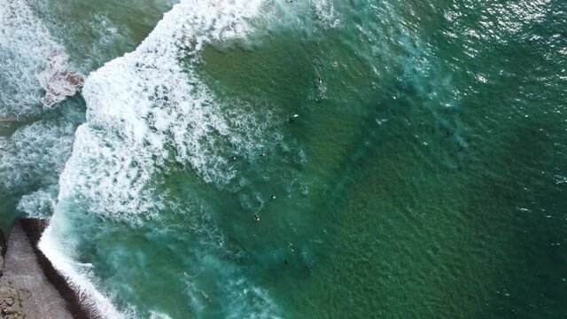 Top down drone shot of a surfen surfing on a wave 4k