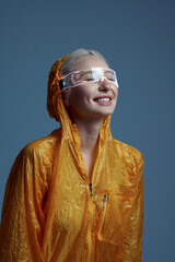Futuristic woman in raincoat and modern glasses